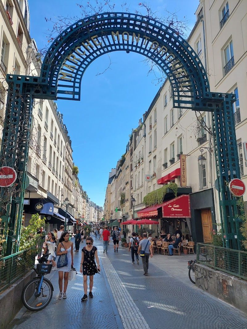 Rue Montorgueil market street in Paris with produce stalls and morning shoppers